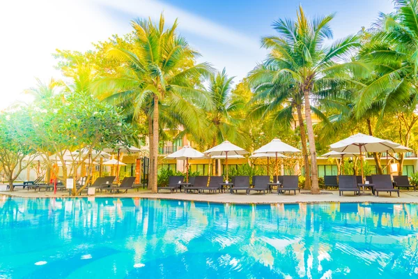 Umbrellas and chairs around hotel swimming pool