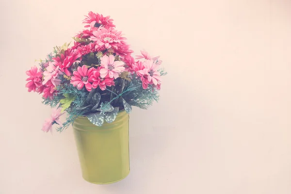 Vase with flowers on wall