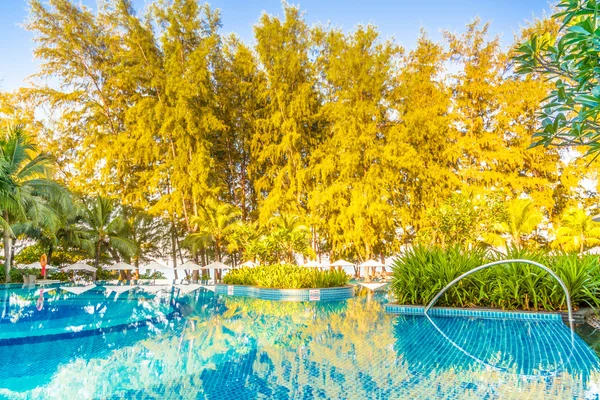 Umbrellas and chairs around hotel swimming pool