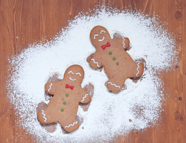Gingerbread man making a snow angel