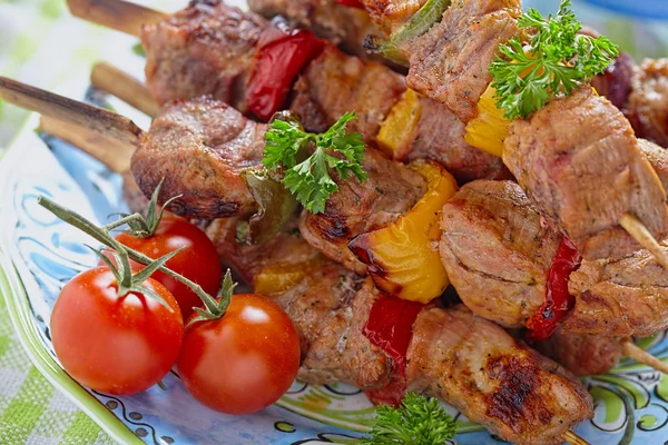 Grilled pork meat and vegetable kebabs