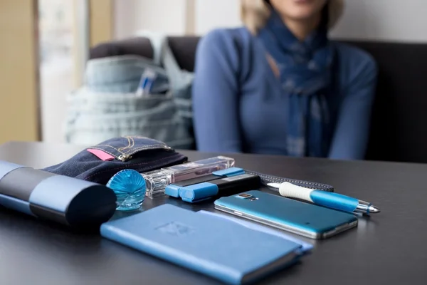 The contents of the women's purse on the table in blue