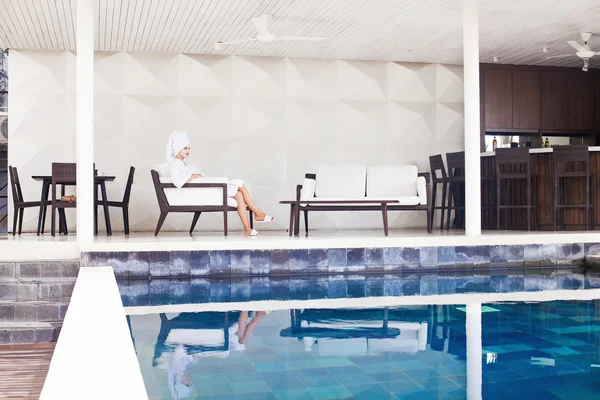 Woman relaxing in swimming pool