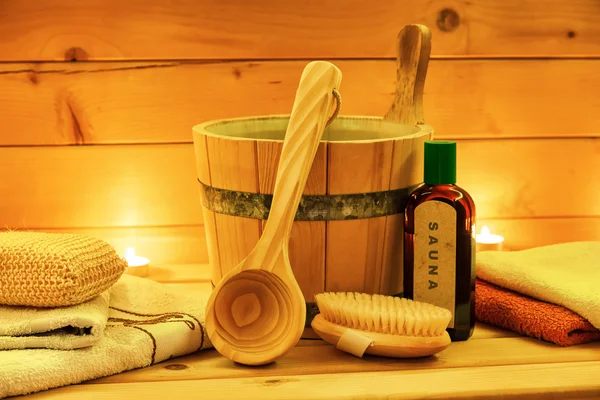 Sauna oil wooden bucket with ladle in closeup
