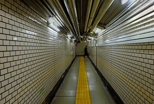 Walking man in subway tunnel