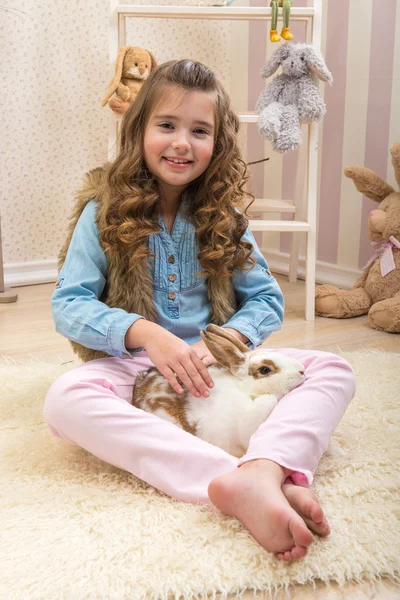 Little girl loves live rabbit
