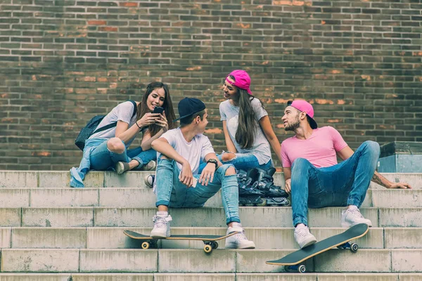 Skateboarders sitting on stairs