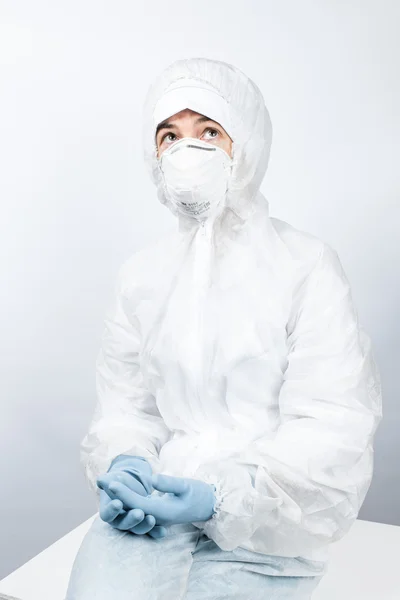 Female professional in hooded suit for bio-hazard protection