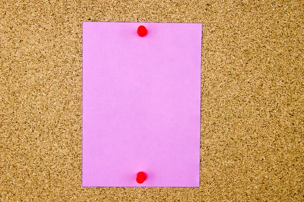 Blank violet paper note pinned on cork board