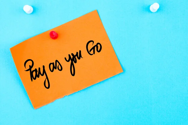 Pay As You Go written on orange paper note