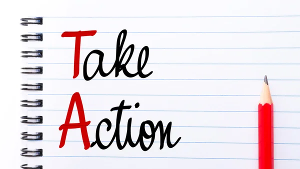 TA Take Action written on notebook page