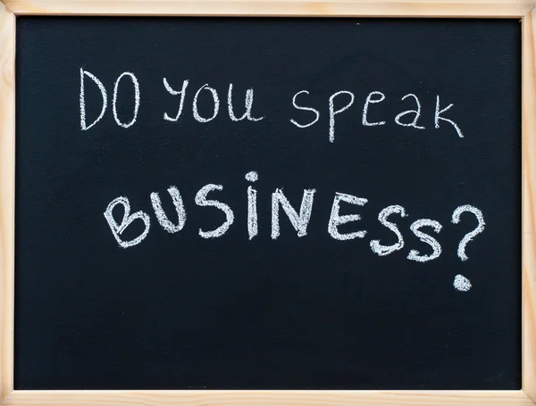 Do you speak business? message written with white chalk on wooden frame blackboard