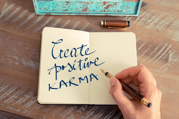 Motivational concept with handwritten text CREATE POSITIVE KARMA