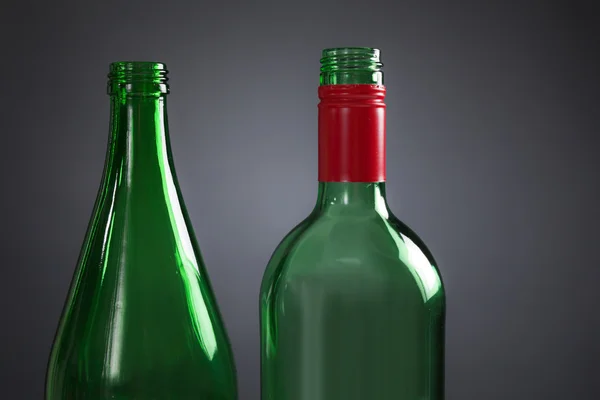 Two empty green bottles