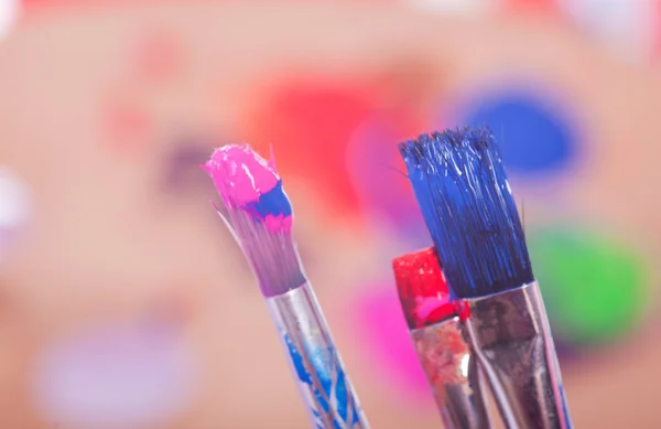 Painting Utensils  in front of colored Pallet