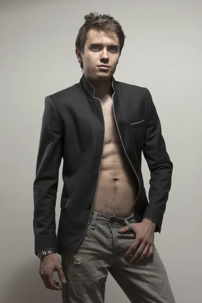 Young good-looking model  in dark suite  with naked torso