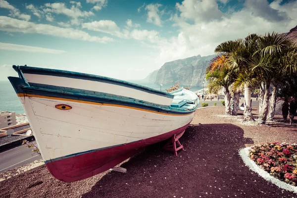 Colourful painted fishing boat near the ocean in Los Gigantes, T