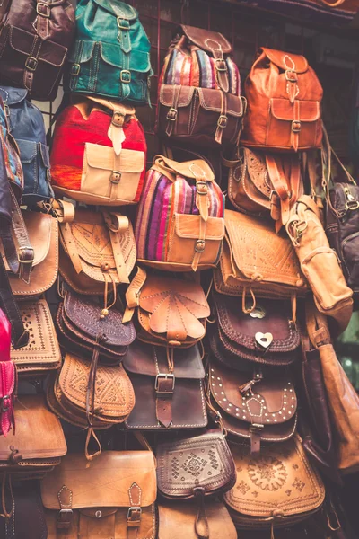 Moroccan leather goods bags in a row at outdoor market