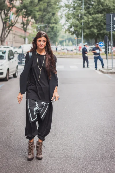 Woman outside Armani fashion shows building for Milan Women's Fashion Week 2014