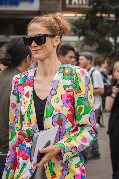 Woman outside Jil Sander fashion shows building for Milan Women\'s Fashion Week 2014