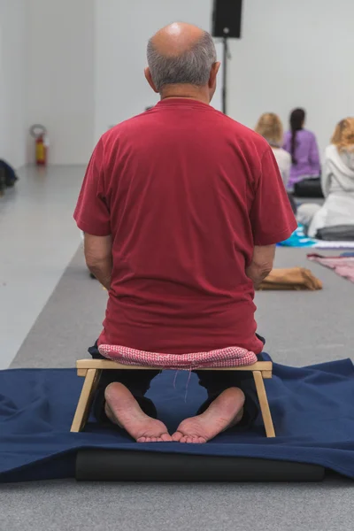 Man takes a class at Yoga Festival 2014 in Milan, Italy