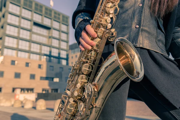 Detail of a young woman with her saxophone