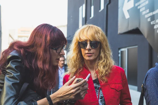 People gather outside Iceberg fashion show building in Milan, It