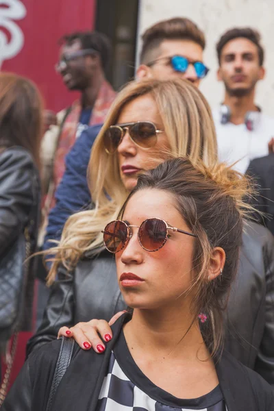 People gather outside Ferragamo fashion show building in Milan,