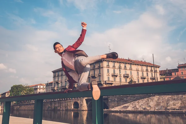 Handsome Asian model jumping in the city streets