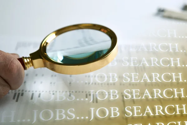 Inscription job search and a hand holding a magnifying glass