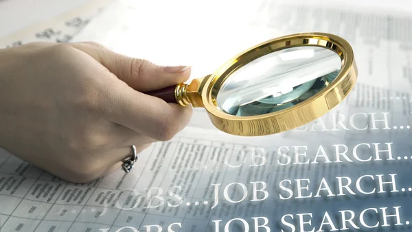 Inscription job search and a hand holding a magnifying glass