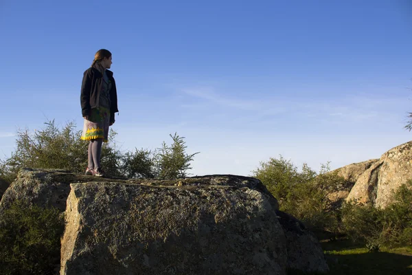 Woman standing on a rocky mountai