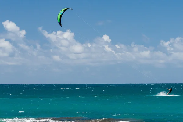 HONOLULU, USA - AUGUST, 14 2014 - People having fun at hawaii beach with kitesurf