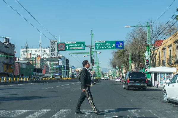 MEXICO CITY, MEXICO - FEBRUARY, 9  2015 - mariachi dressed man crossing the street