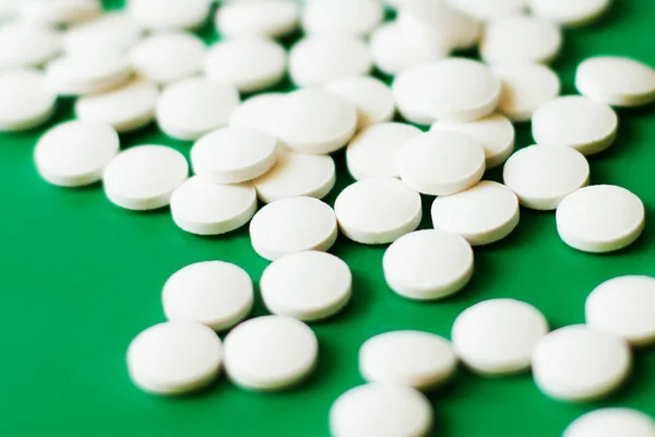 Pills on green background, differential focus