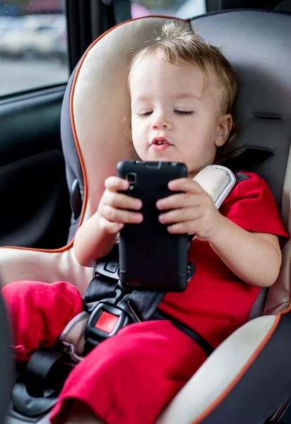 Toddler boy playing smartphone