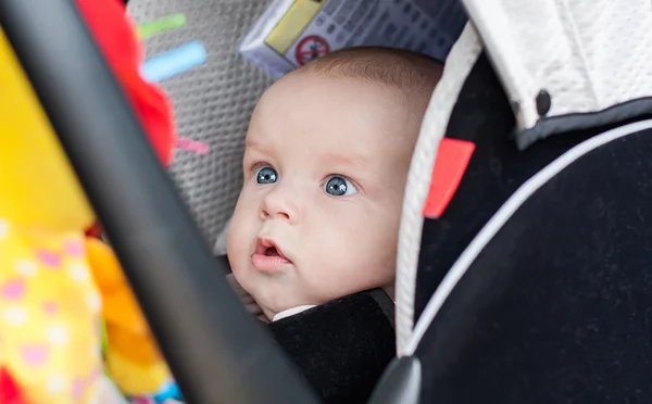 Baby boy in car seat stares