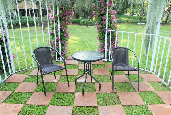 Wicker chair in the garden decorated with tiled floor