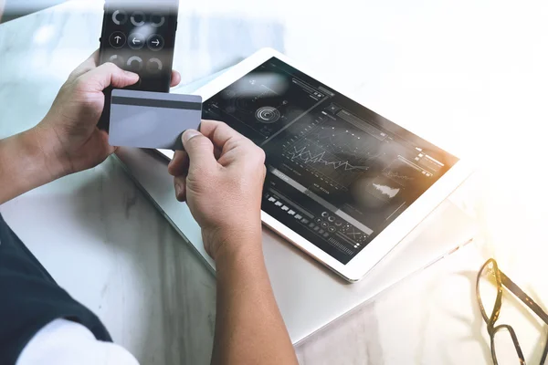 Businessman hands holding plastic credit card and using digital