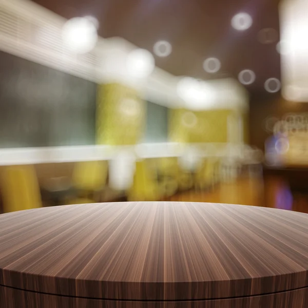 Empty wooden round table and blurred background for product pres