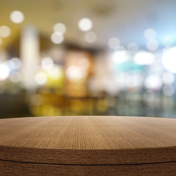 Empty wooden round table and blurred background for product pres