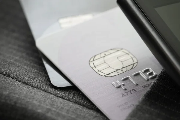 Credit cards in very shallow focus with gray suit background