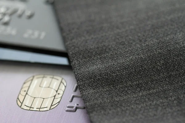 Credit cards in very shallow focus with gray suit background