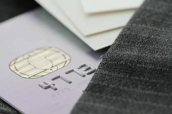 Credit cards in very shallow focus  with gray suit background