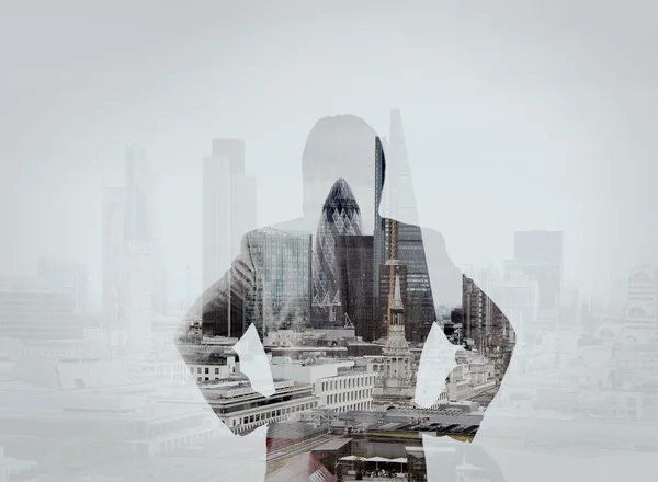Double exposure of businessman stands successfully on building t