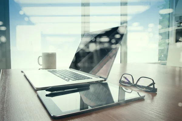 Office workplace with laptop and smart phone on wood table with