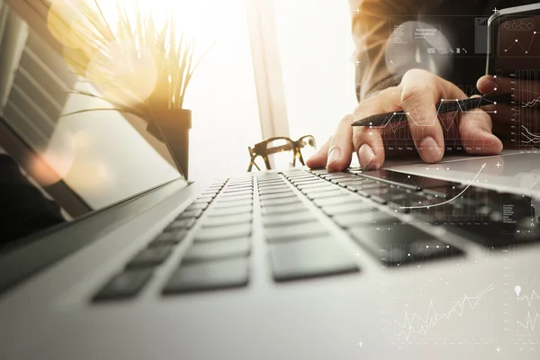 Businessman hand working with new modern computer and business s