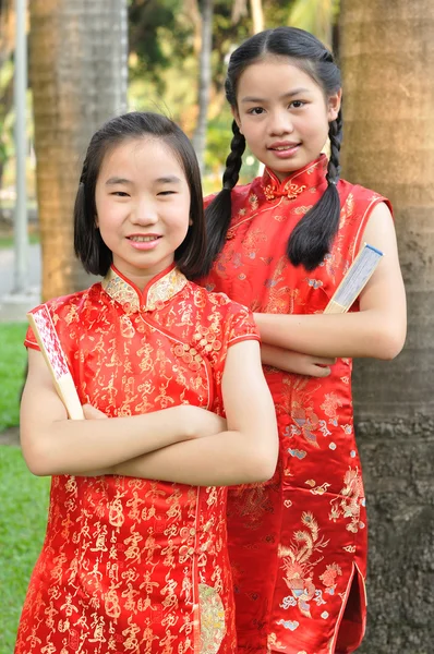 Asia female teenagers wear red suit pose for take photo in garde