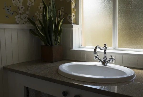 Old retro water tap basin in modern bathroom