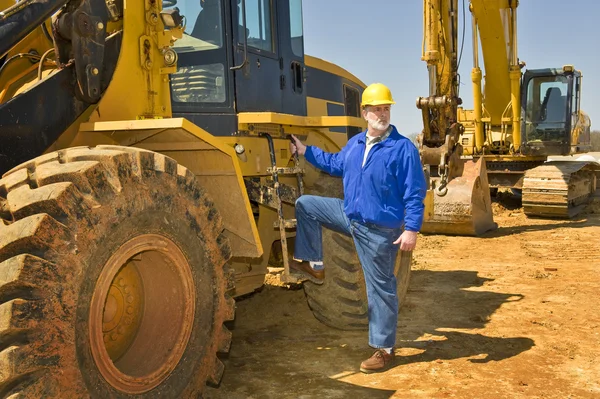 Highway Construction Worker With Heavy Equipment